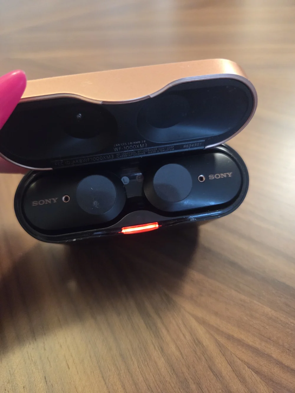Sony WF-1000XM3 wireless noise-canceling earbuds inside their charging case